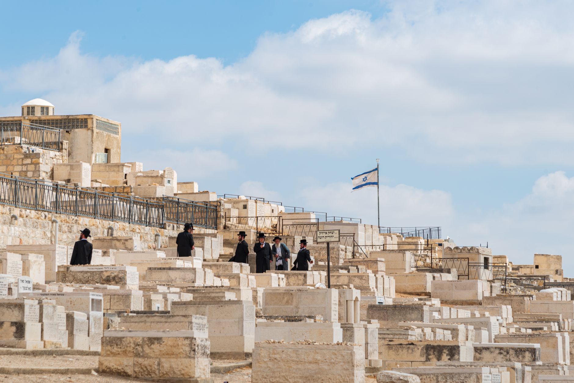 A group of travelers walking together through an ancient stone street in Jerusalem